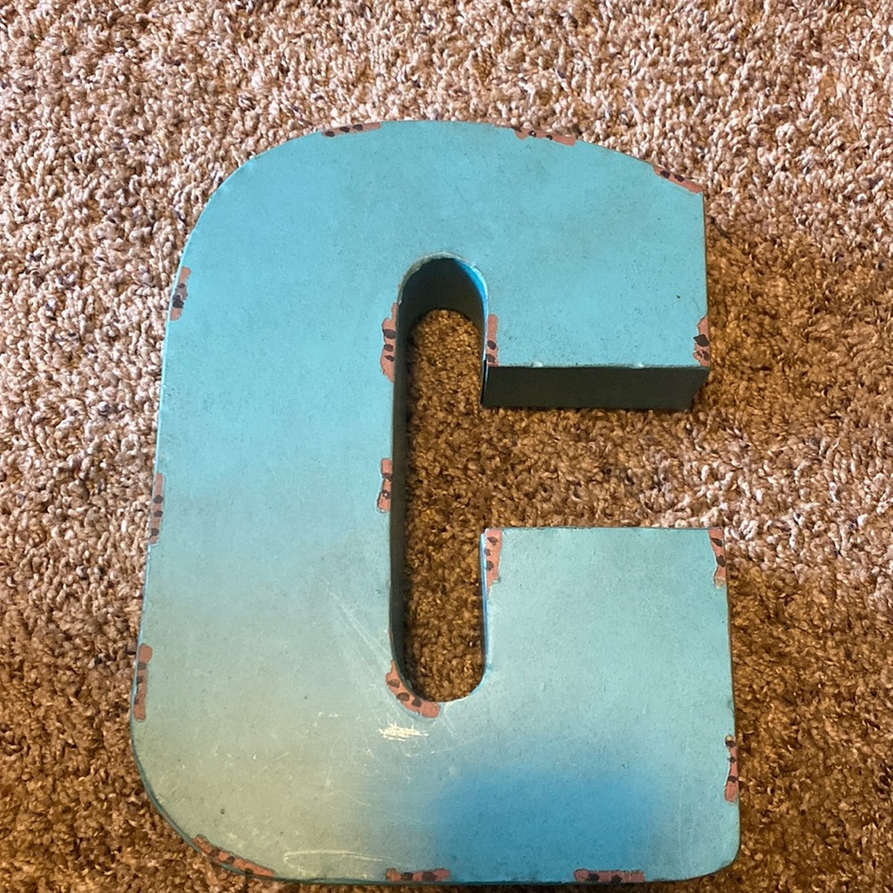 Metal letter “c” sign